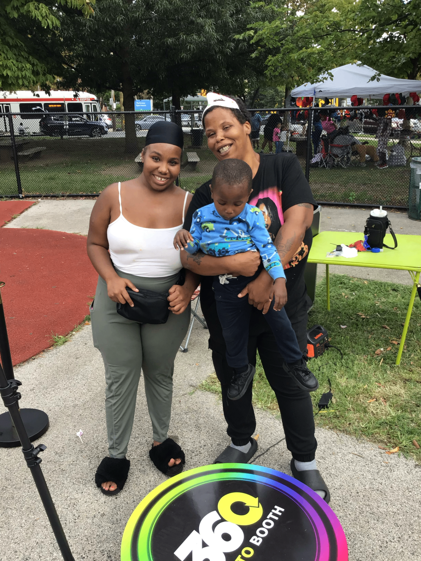 Family smiling next to the 360 photo booth platform